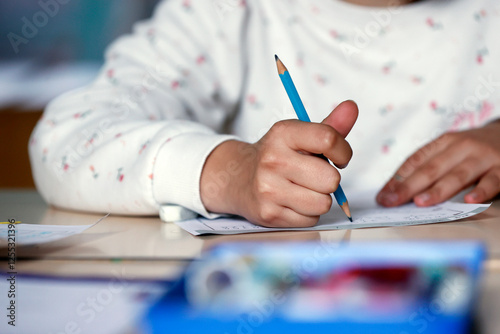 Primary school classroom with a pupil writing is work.   France. photo