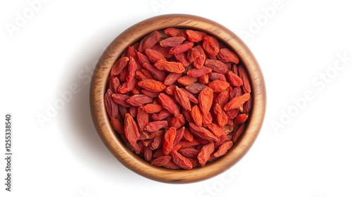 Dried red goji berries in wooden bowl center top down view, white background