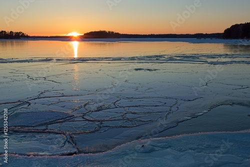 Scenic view of seashore at sunset in winter with frozen sea, Kallahdenniemi, Helsinki, Finland. photo