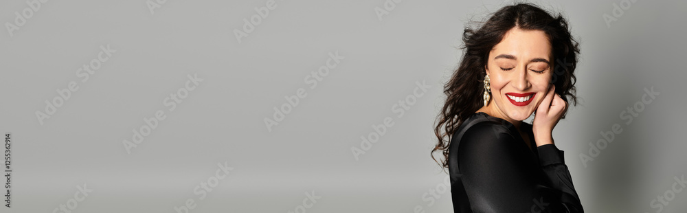 Beautiful young woman in elegant black attire poses gracefully in a studio setting Beautiful young woman in elegant black attire poses gracefully in a studio setting