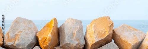 Coastal Minimalism Golden Rock Formation Against Ocean Backdrop for Sustainable Design and Eco-Friendly Commercial Marketing Initiatives photo