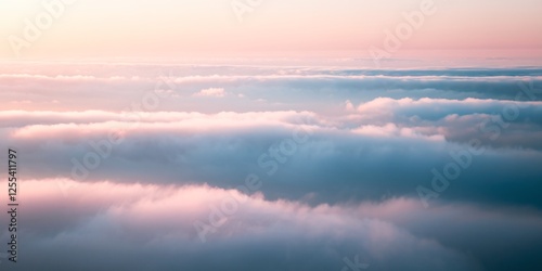 Fototapeta Naklejka Na Ścianę i Meble -   Tranquil Layers of Clouds at Sunrise. A serene view of soft, layered clouds bathed in the gentle hues of sunrise, evoking a sense of peace and endless possibility in the sky.