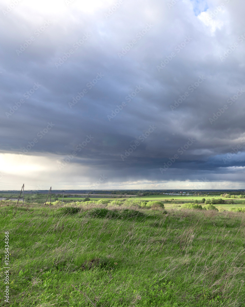 Cloudy sky with a storm brewing in the distance Cloudy sky with a storm brewing in the distance