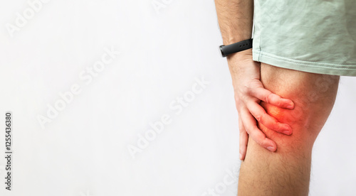 The man grabbed his knee due to severe pain photo