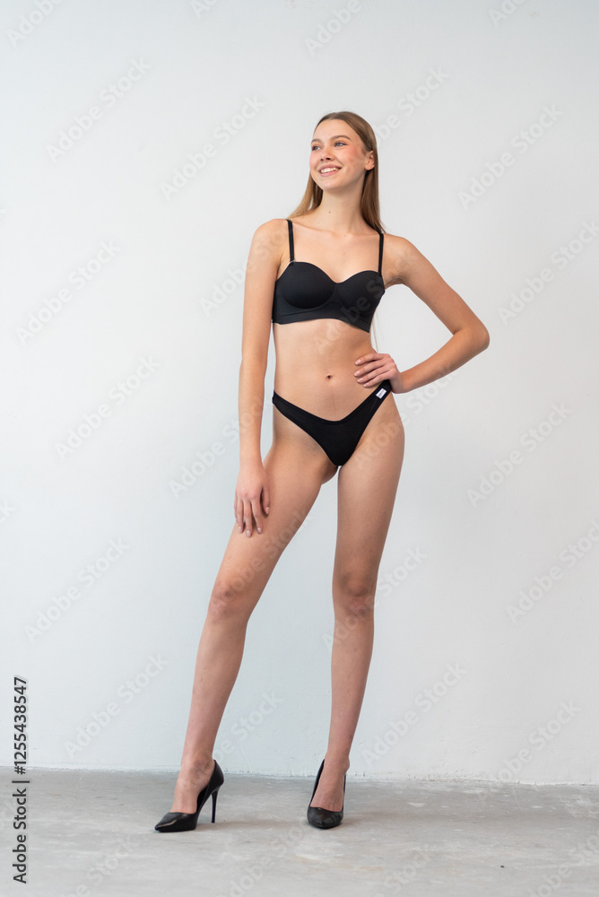 Casting snapshot of a fresh-faced model in simple black underwear, highlighting her natural features, body proportions, and confident stance. Ideal for agency scouting and professional portfolio updat Casting snapshot of a fresh-faced model in simple black underwear, highlighting her natural features, body proportions, and confident stance. Ideal for agency scouting and professional portfolio updat
