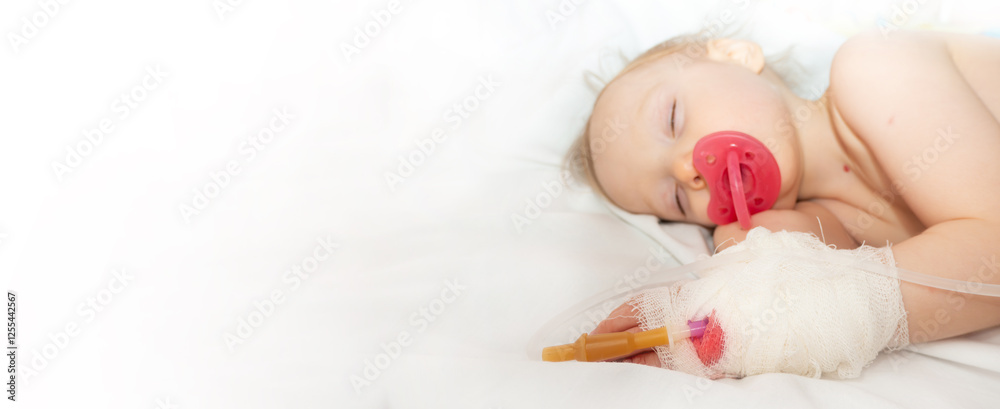 Babygirl sick and sleeping on patient bed at the hospital. Saline intravenous or (IV)drip in baby patient hand. Poor baby looks tired and exhausted.IV fluid replacement or correcting the dehydration
