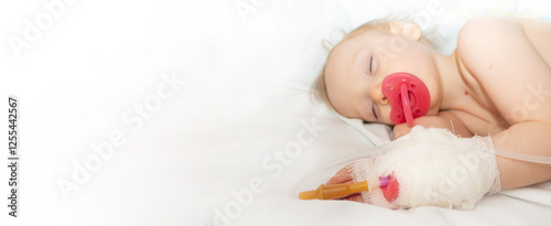 Obraz na płótnie Babygirl sick and sleeping on patient bed at the hospital. Saline intravenous or (IV)drip in baby patient hand. Poor baby looks tired and exhausted.IV fluid replacement or correcting the dehydration w salonie