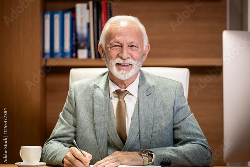 Fotografi Portrait of caucasian bearded businessman sitting in his luxury office