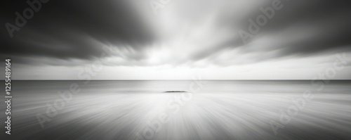 Dramatic black and white seascape with stormy sky and blurred waves