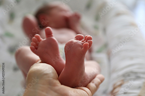 Mother holding baby daughter's feet