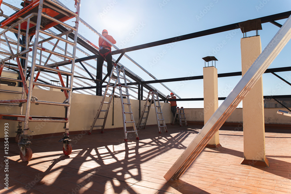Construction workers installing metal structure for solar panels on rooftop Construction workers installing metal structure for solar panels on rooftop