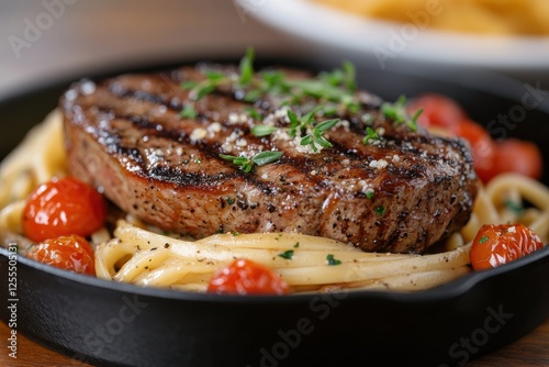A visually striking dish featuring gourmet grilled steak served alongside al dente pasta and sun-kissed cherry tomatoes, mouthwatering and satisfying for any meal.