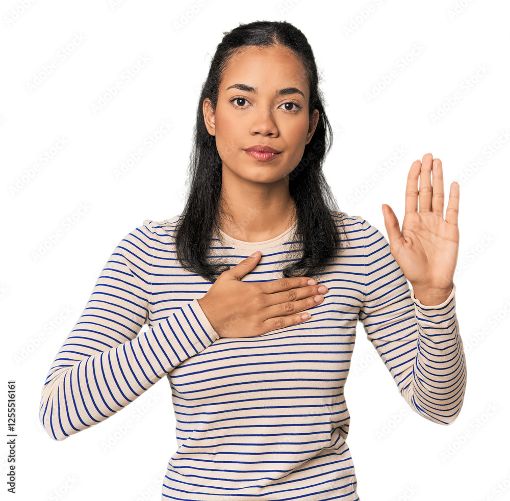 Young Filipina woman taking an oath, putting hand on chest. Young Filipina woman taking an oath, putting hand on chest.