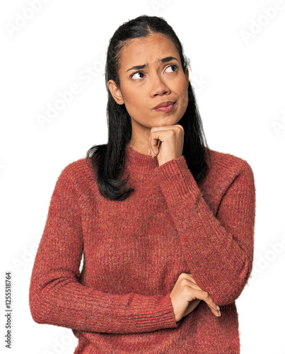 Fotografie Young Filipina woman thinking and looking up, being reflective, contemplating, having a fantasy
