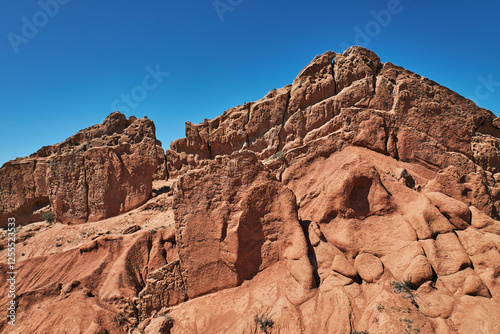 Fairy Tale Canyon on the southern shore of Issyk-Kul lake, Kyrgyzstan. Picturesque travel destination, landmark Kirgiziya. Summer skazka canyon with colorful rocks and hills. Natural park landscape photo