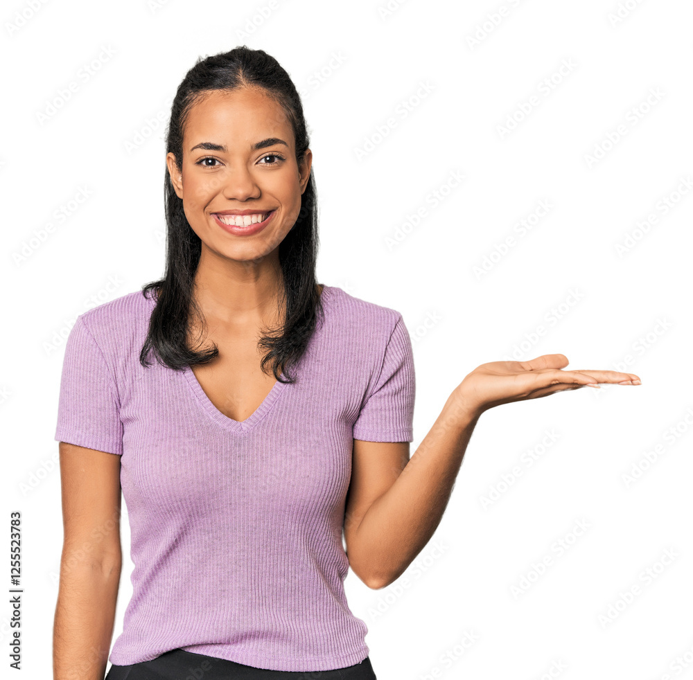 Young Filipina woman showing a copy space on a palm and holding another hand on waist. Young Filipina woman showing a copy space on a palm and holding another hand on waist.