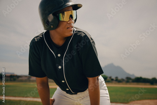 Baseball player focused in the batter's box wearing a helmet and sunglasses