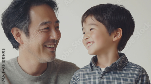Obraz na płótnie 笑顔の男の子とお父さんが向かい合って話し合っているスタジオで撮影した記念写真 幼児 小学生 低学年 1年生 w salonie