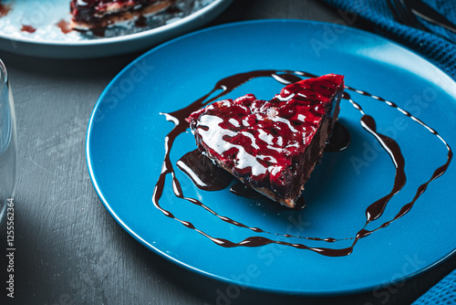 Cherry clafoutis with chocolate on a blue plate. French Cherry Dessert photo