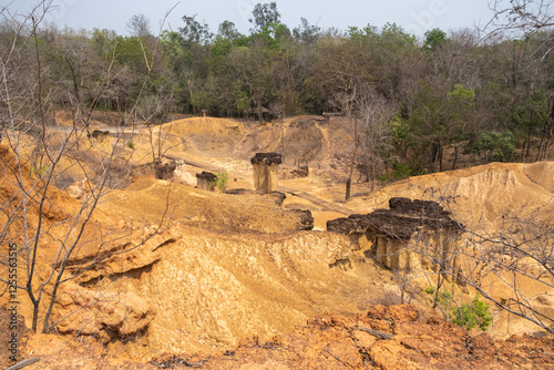 Stunning rock formations at Phae Mueang Phi Forest Park in Phrae, Thailand. A unique geological wonder with rugged sandstone pillars shaped by natural erosion. photo