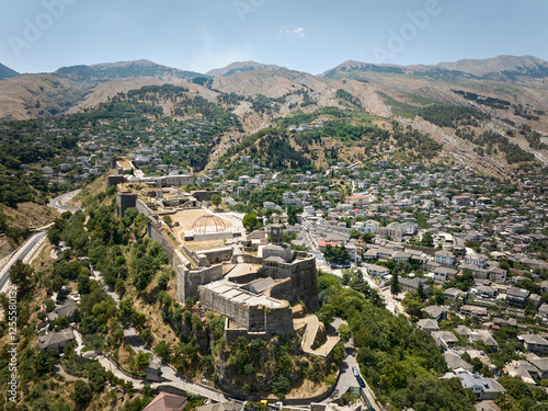 Aerial panoramic drone view of Gjirokaster with its historical castle (aka Gjirokaster Fortress, Gjirokaster Castle), Albania
