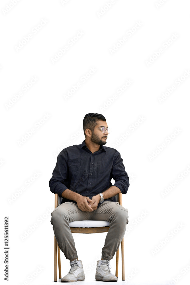 A man, on a white background, in full height, sitting on a chair A man, on a white background, in full height, sitting on a chair