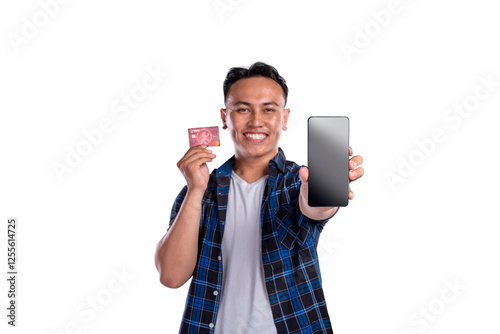 Wallpaper Mural Portrait of Asian Indonesian man in shirt showing his credit card and blank mobile phone screen isolated over white background. Copy space or mockup. Concept of technology, communication, or shopping Torontodigital.ca