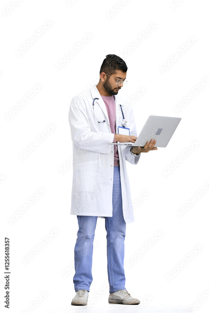 A male doctor, on a white background, in full height, uses a laptop A male doctor, on a white background, in full height, uses a laptop