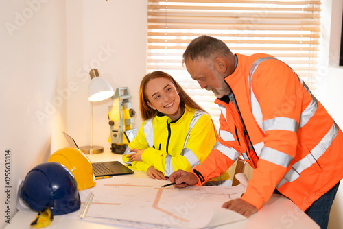 Male and female Construction professionals collaborate on project plans in a well-lit office photo