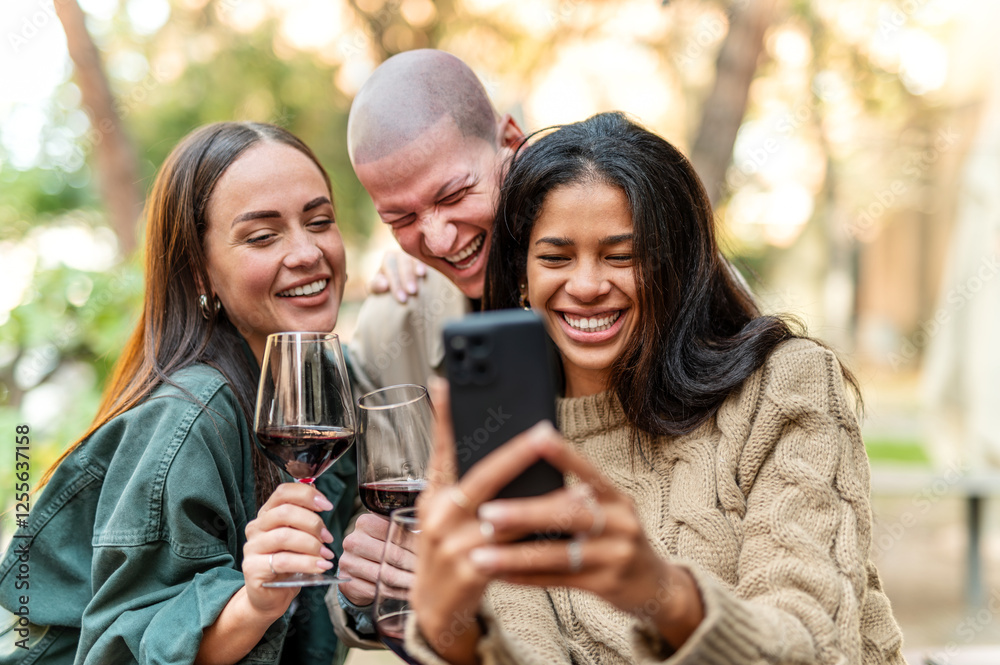 Young friends having fun drinking red wine at winery bar - Happy people sharing content on mobile phone together at open air restaurant garden - Food, beverage and Tech, modern life style concept Young friends having fun drinking red wine at winery bar - Happy people sharing content on mobile phone together at open air restaurant garden - Food, beverage and Tech, modern life style concept