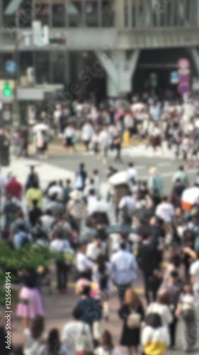 Wallpaper Mural SHIBUYA, TOKYO, JAPAN : Aerial top view of Shibuya crossing in daytime. Crowd of people at the street. Japanese people, society and diversity concept video. Blurred vertical shot. Torontodigital.ca