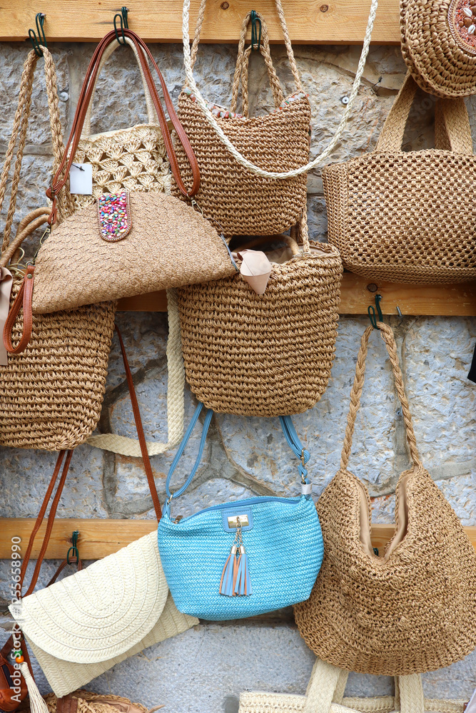 Straw hand bags for sale at showcase in Pollenсa, Balearic Islands, Spain