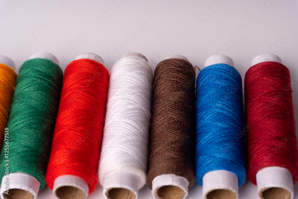 Colorful sewing thread set and needles isolated on background.
Colorful sewing thread set and needles isolated on background.