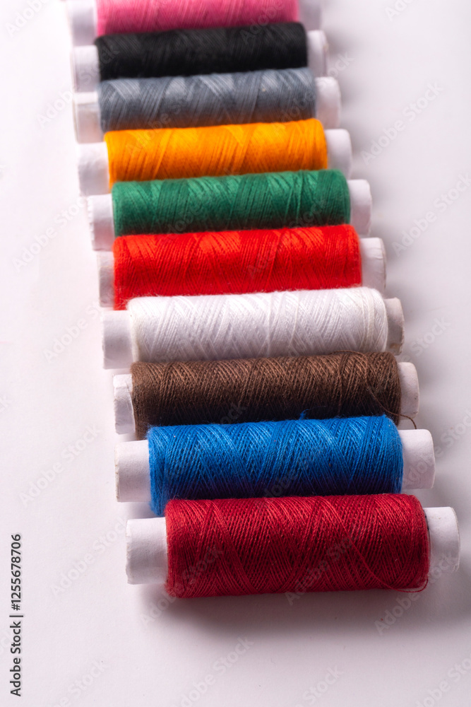 Colorful sewing thread set and needles isolated on background.
Colorful sewing thread set and needles isolated on background.