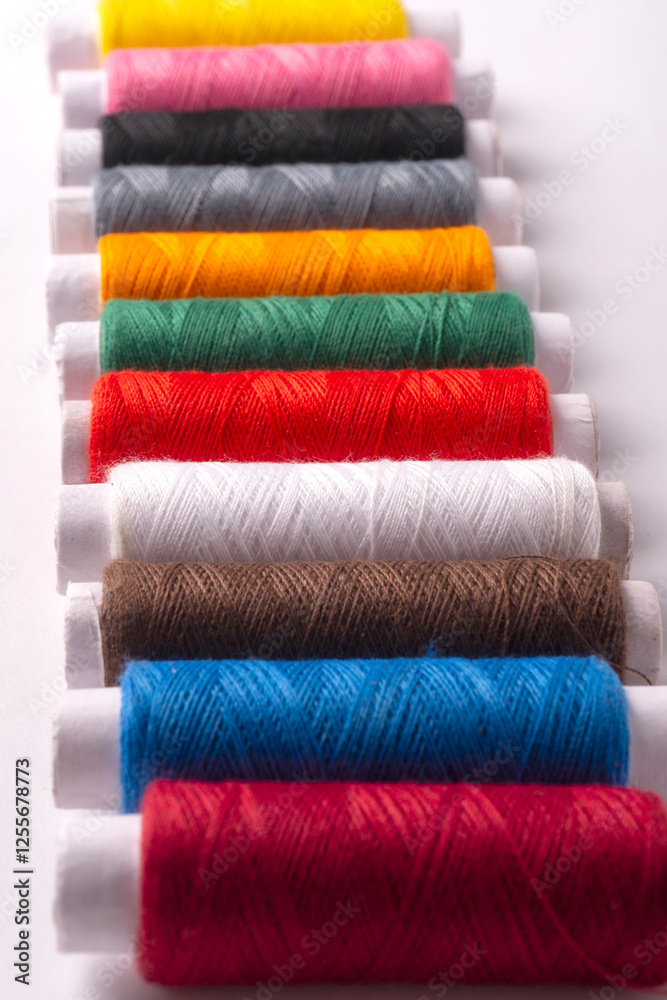 Colorful sewing thread set and needles isolated on background.
Colorful sewing thread set and needles isolated on background.