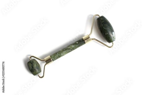 Wallpaper Mural Green stone facial massager lies on white background.	 Torontodigital.ca