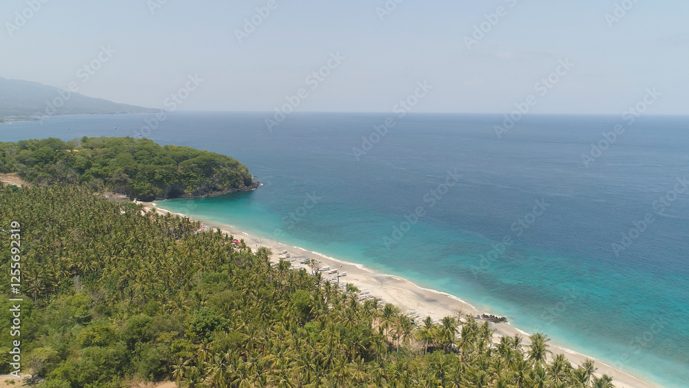 sandy beach with palm trees in tropical resort. aerial seascape sand beach with turquoise water. Seascape, ocean and beautiful beach.Travel concept. Indonesia, Bali sandy beach with palm trees in tropical resort. aerial seascape sand beach with turquoise water. Seascape, ocean and beautiful beach.Travel concept. Indonesia, Bali
