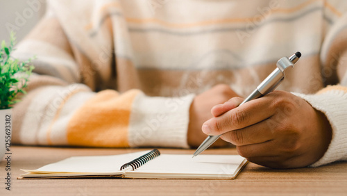 Male hand taking notes on the notepad. businessman working at work table, checklist writing planning investigate enthusiastic concept. focus on man hand holding pen, putting signature at official pape