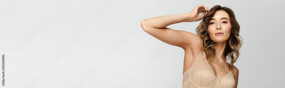 Elegant young woman showcasing modern lingerie style in a chic and minimalistic setting Elegant young woman showcasing modern lingerie style in a chic and minimalistic setting