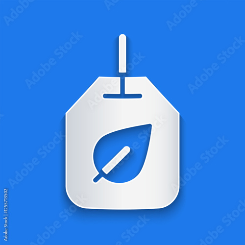 Paper cut Tea bag with leaf icon isolated on blue background. Paper art style. Vector