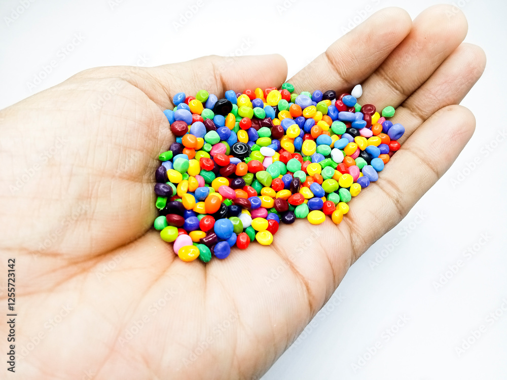 Plastic masterbatch mix color granules in open hand grip, polymer carrying colorful pigments isolated on white background, suitable for industrial plastic company profile product catalog design Plastic masterbatch mix color granules in open hand grip, polymer carrying colorful pigments isolated on white background, suitable for industrial plastic company profile product catalog design