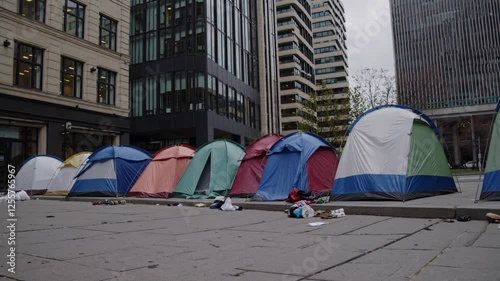 Slow Motion City Homeless Tents | Static Shot Fixed Camera Movement | Rows of Makeshift Shelters on Urban Streets | Harsh Reality of Homelessness | Wind Gently Moving Fabric | Gritty and Emotional