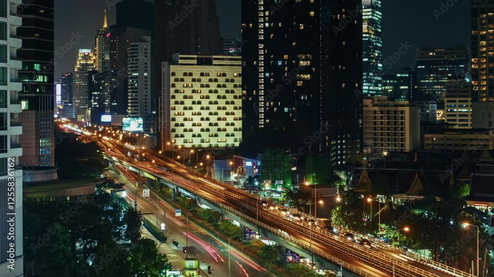 timelapse Nighttime panoramic view of Bangkok showcasing a busy highway. Skyscrapers illuminate the skyline, while streams of vehicle lights create a lively atmosphere. Urban landscape aesthetics