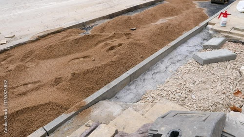 Laying of paving stones - asphalt and sand, construction site