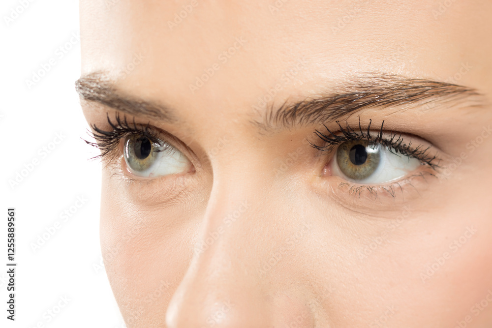 Fototapeta premium Extreme close-up of clear, hazel-green eyes with defined lashes, showcasing natural beauty and subtle makeup details