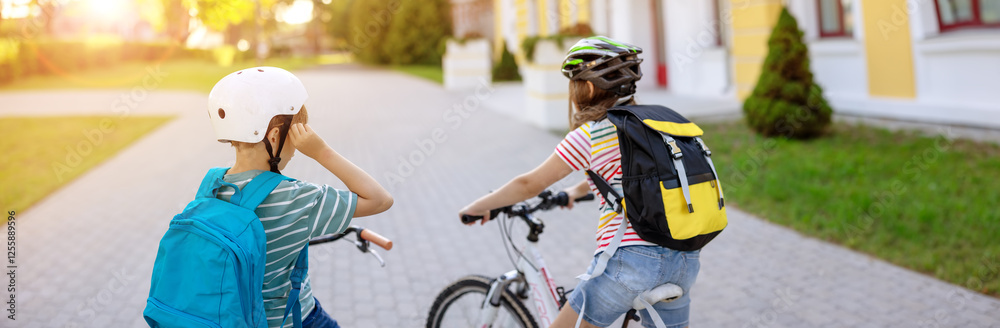 Fototapeta premium Boy and girl on the bicycles riding together.