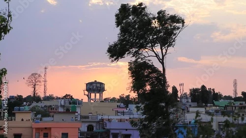 The sun is setting and the wind is blowing in the evening. sky is turnin red. A beautiful scene. A village in Dehradun. Uttarakhand. india. 05- 26-2020 photo