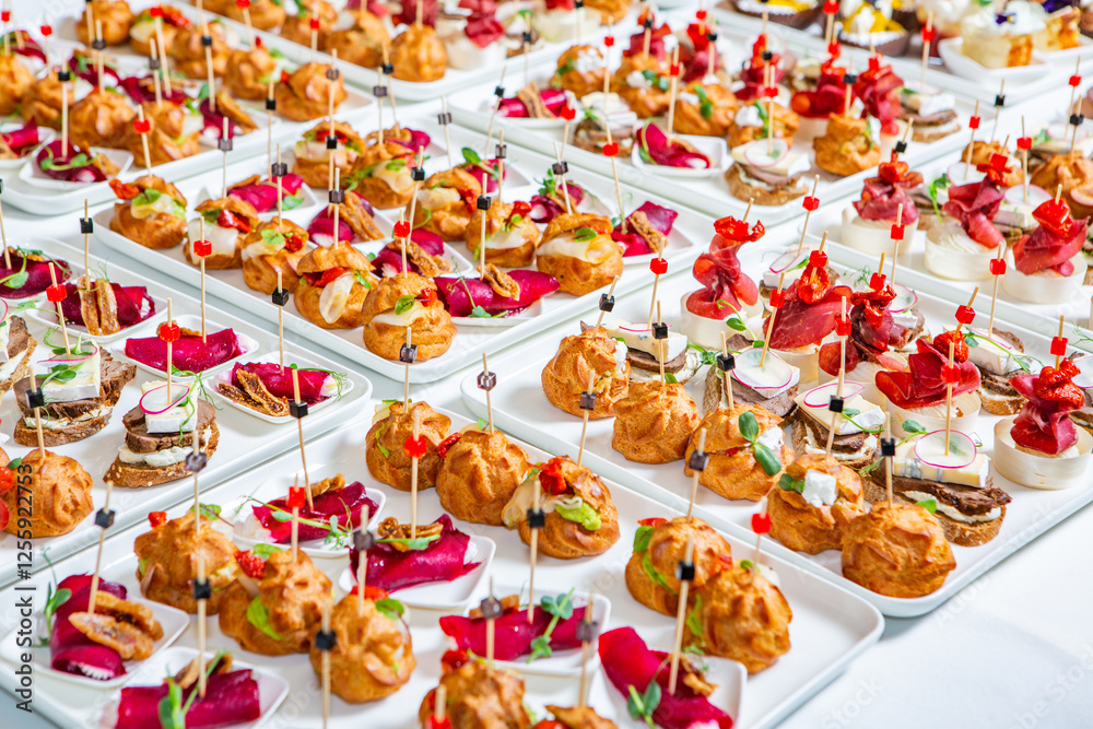 Fototapeta premium Catering buffet or service with different snacks, appetizers and canapes on a table. Variety of Freshly Prepared Catering Food for an Event.