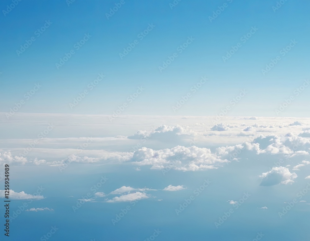 Fototapeta premium Serene blue sky with soft white clouds, creating a tranquil aerial view.