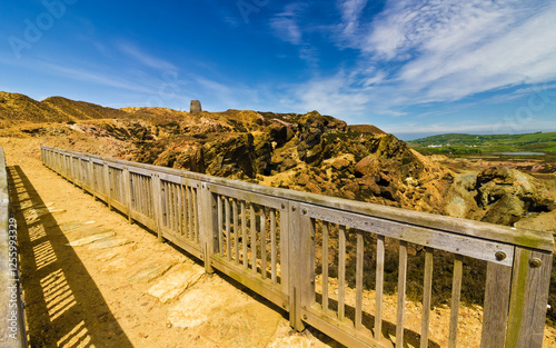 Open-cast copper mine trail footbridge scene, featuring the Grade II Listed windmill in the distance, Parys Mountain, Amlwch, Anglesey, Gwynedd photo